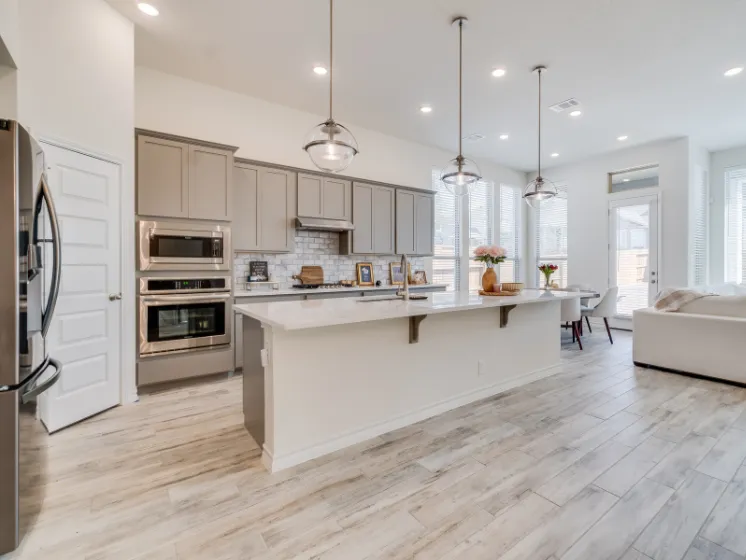 Professional kitchen remodeling project by Kitchen Pro Dallas, featuring a modern open-concept kitchen with custom cabinetry, island, and updated lighting