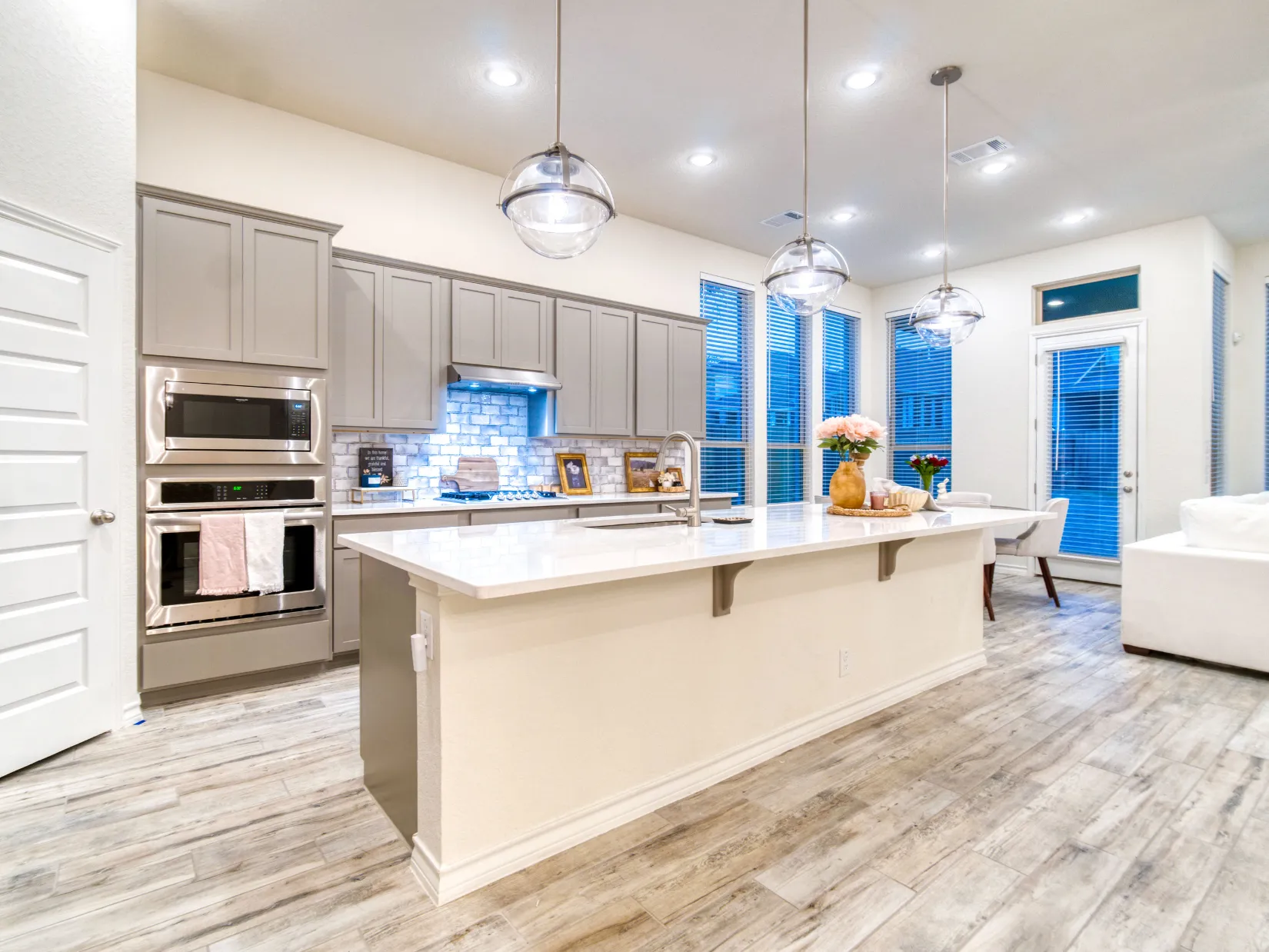 Custom kitchen remodeling in Dallas TX with quartz island, modern cabinetry, recessed lighting, and open concept design