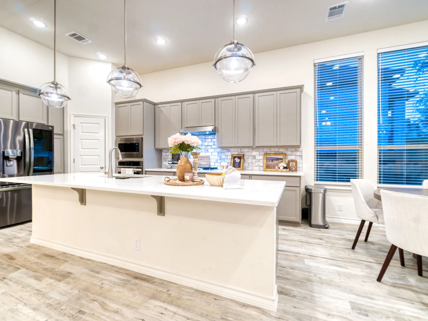 Professional kitchen remodeling project in Dallas TX featuring a modern kitchen with large island, pendant lighting, and open layout
