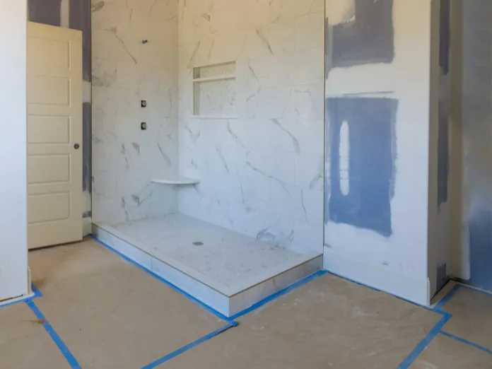 Modern bathroom remodeling project featuring a walk-in shower conversion with marble tile finishes in Dallas, TX
