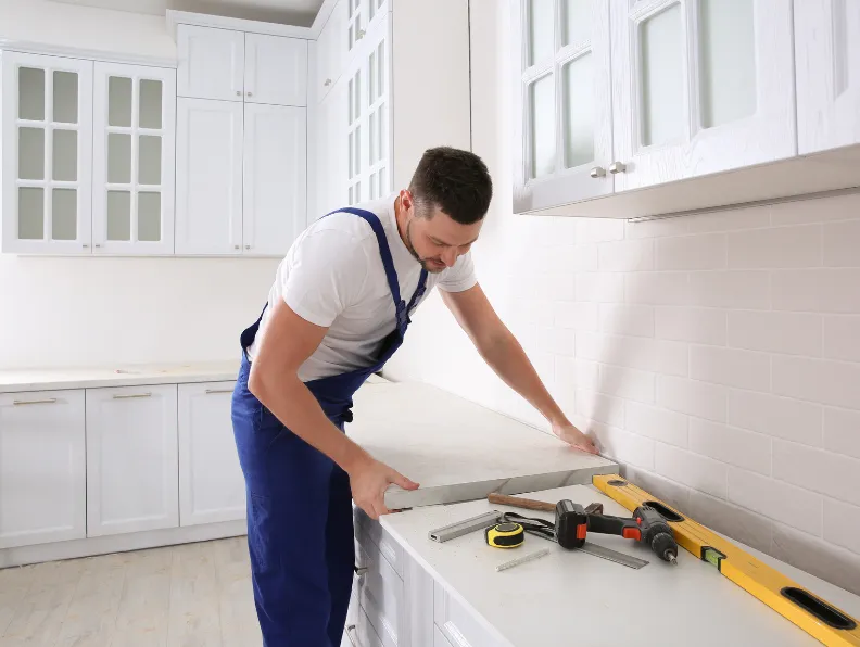Professional kitchen cabinet installation in Dallas TX with expert contractor measuring and fitting custom cabinetry